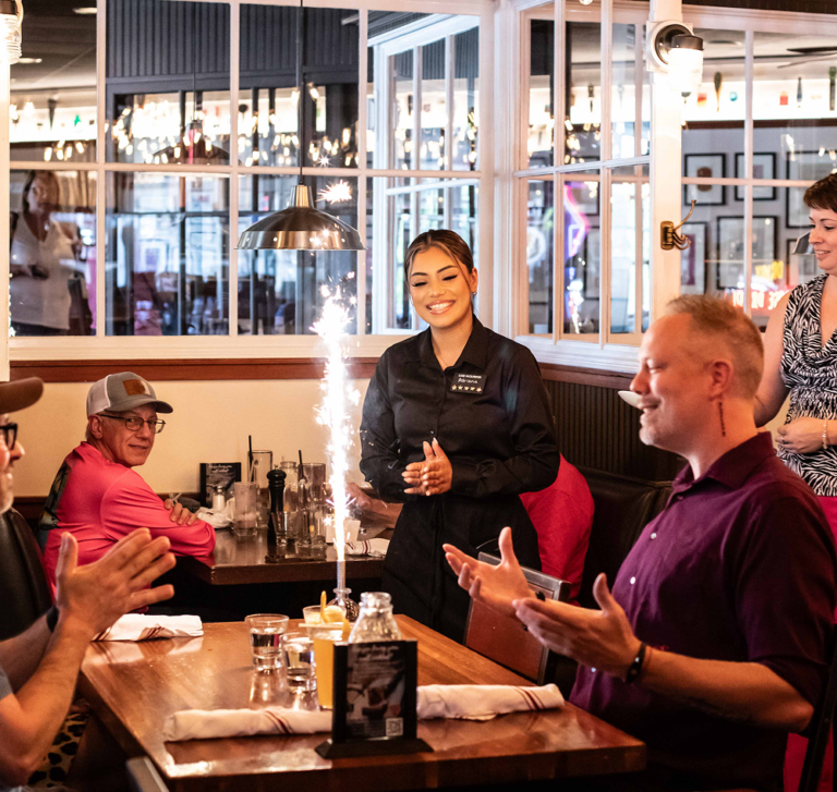 team member and customers watching sparkling display