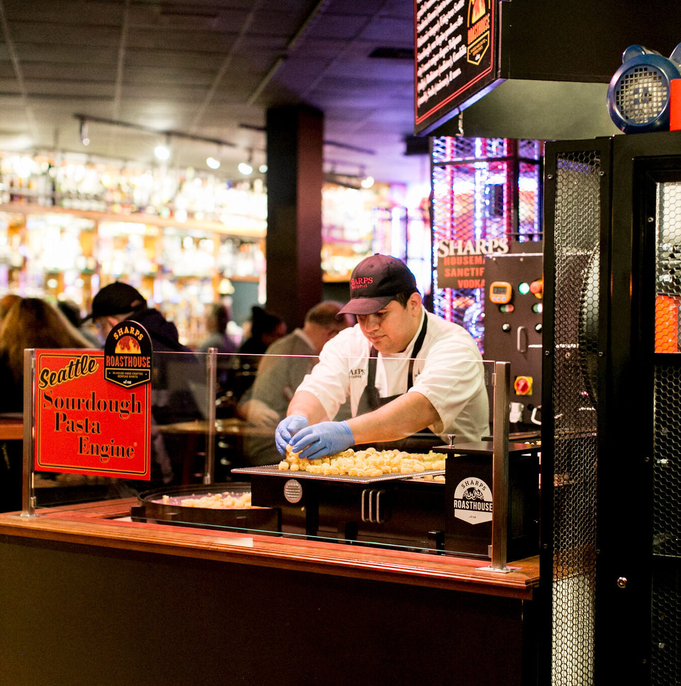 Chef preparing fresh sourdough pasta at the Sharps RoastHouse pasta station inside the restaurant.