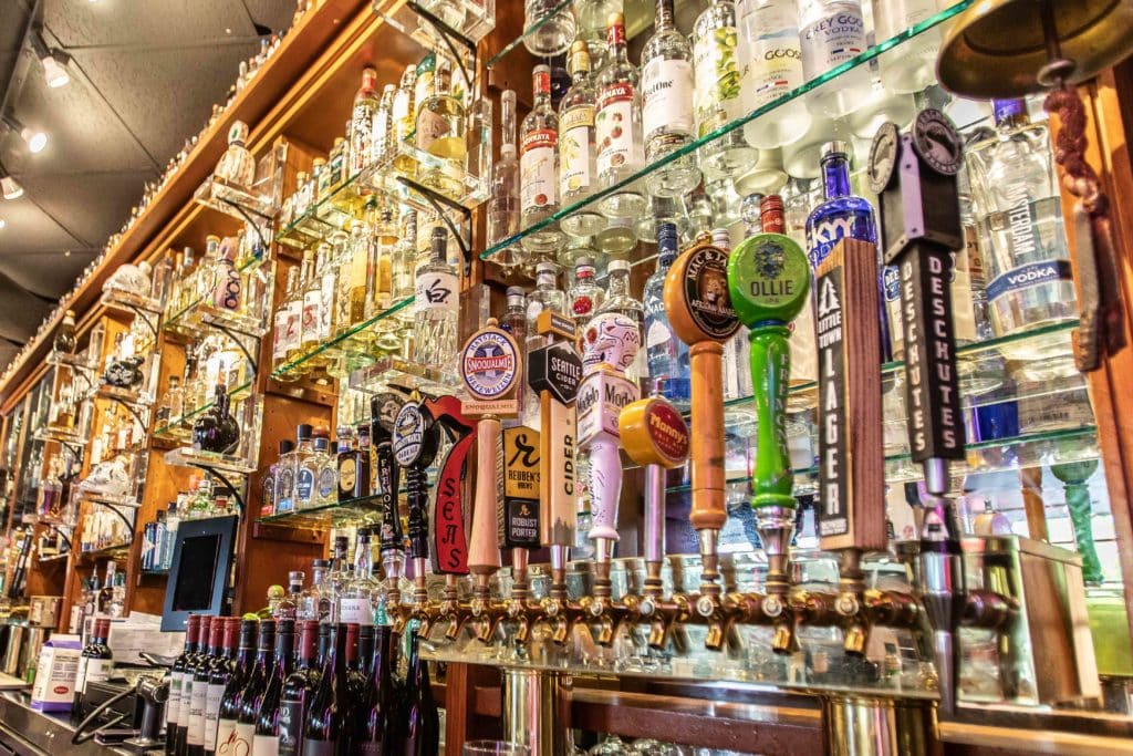 Interior photo of Sharps Bar. Many draft beer handles and an impressive selection of liquor is displayed on the wall.