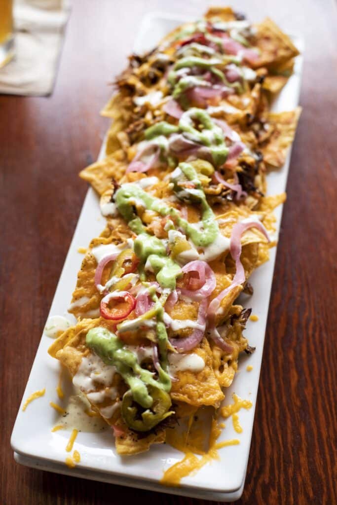 Bar Boss Bourbon™ BBQ Pork Nachos sitting on wooden table