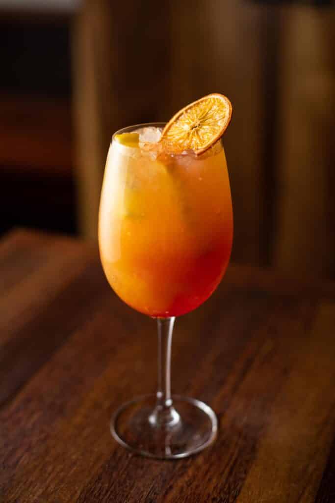 Tropically inspired mocktail containing a mixture of citrus, passionfruit, and ginger beer. Try it with Bar Boss™ Gin and Aperol if you'd like the cocktail experience.